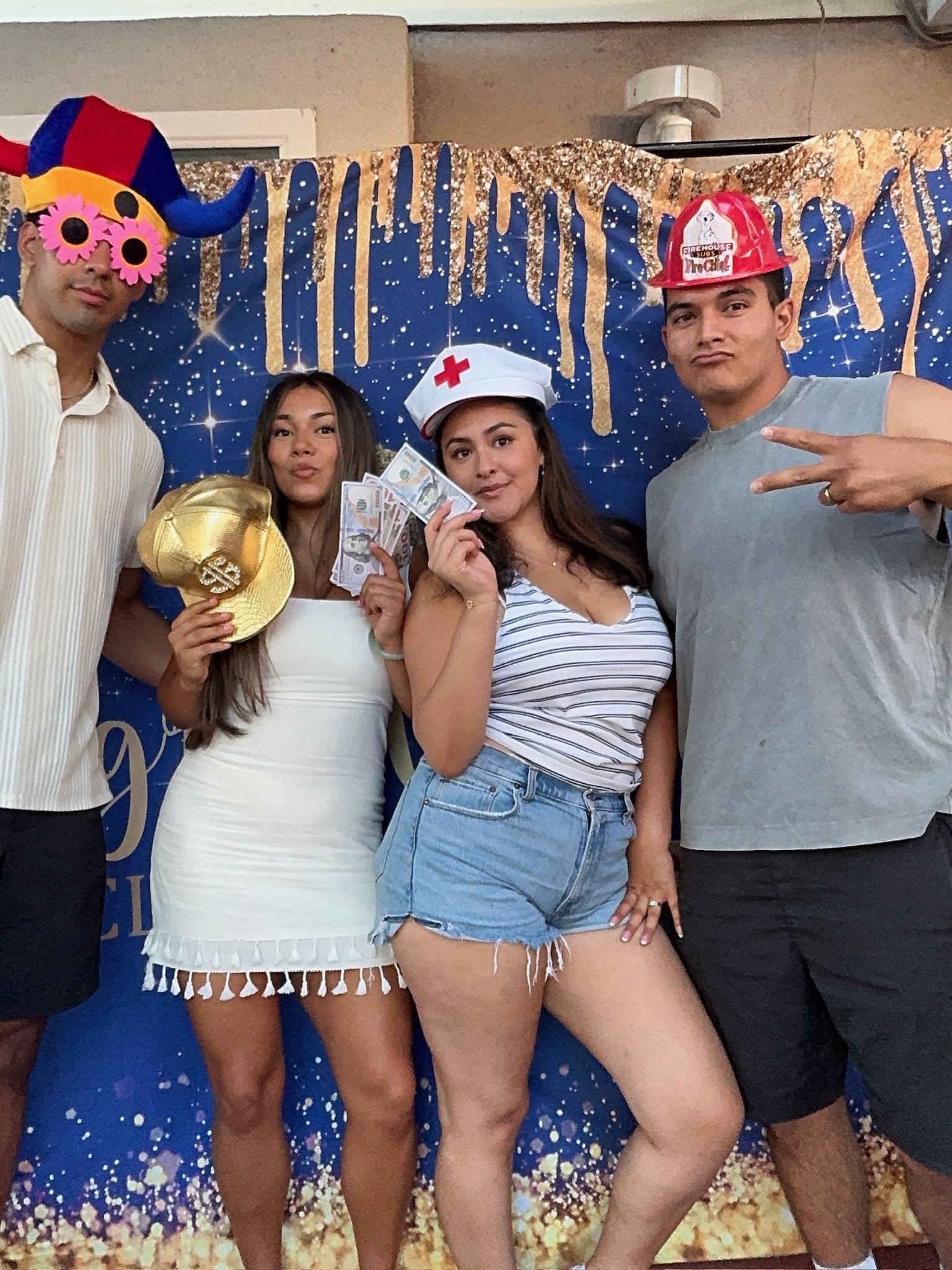 Guests having fun with hats and props at a JB Photo Booth event